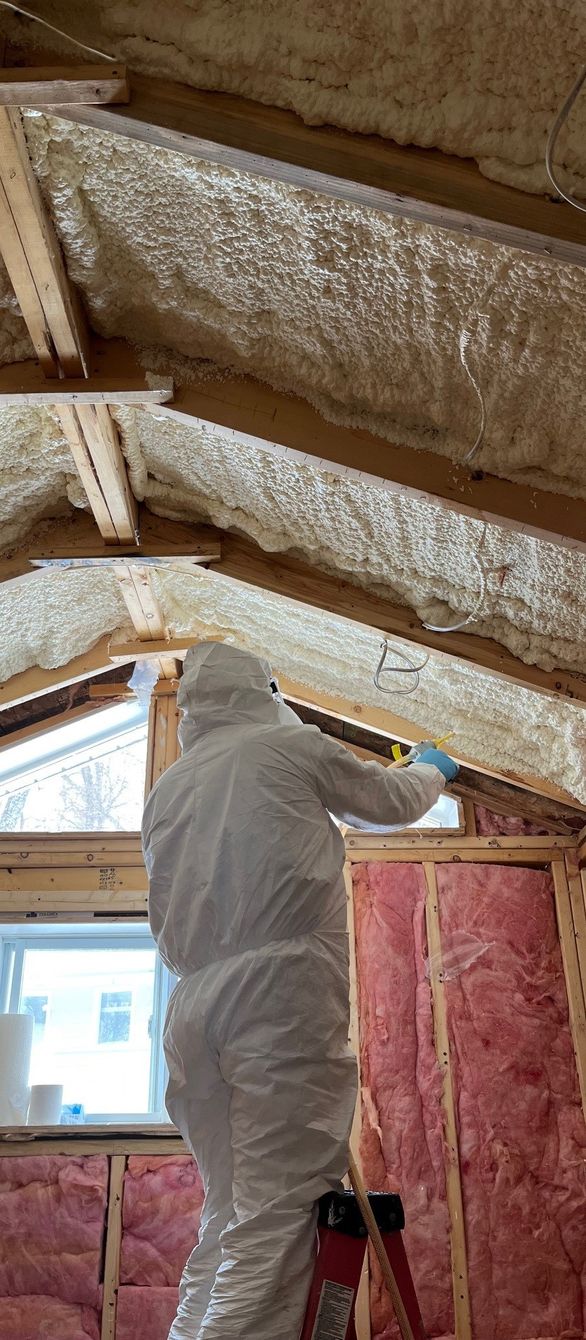 Person installing insulation in a roof